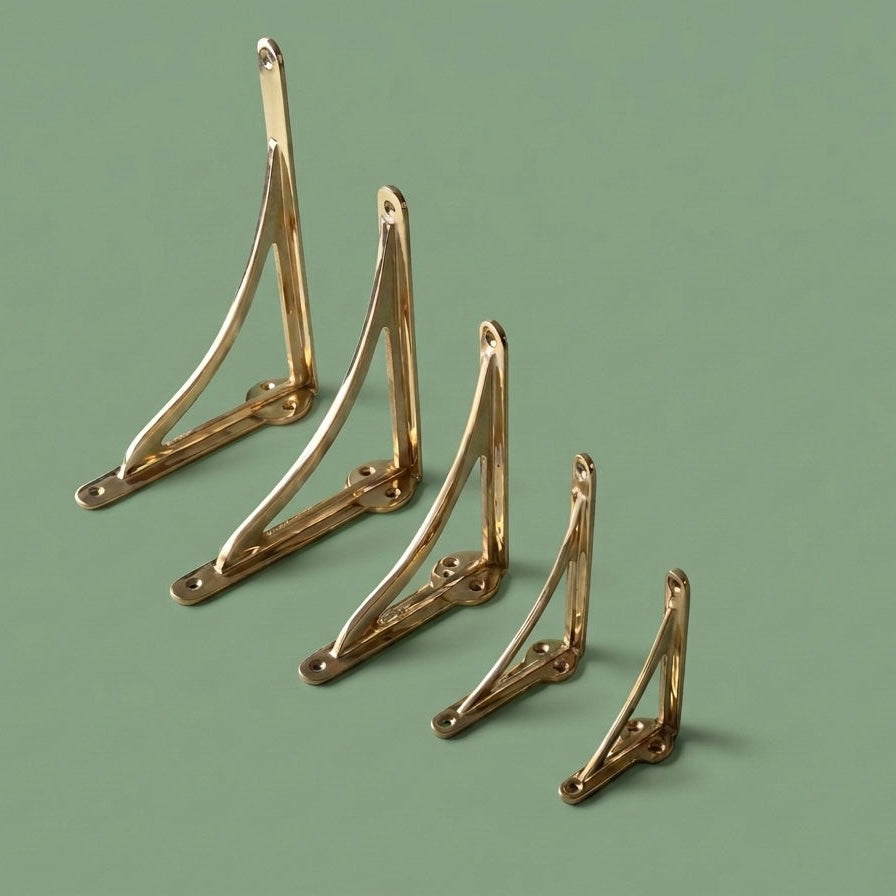 Set of gold metal brackets on a green background