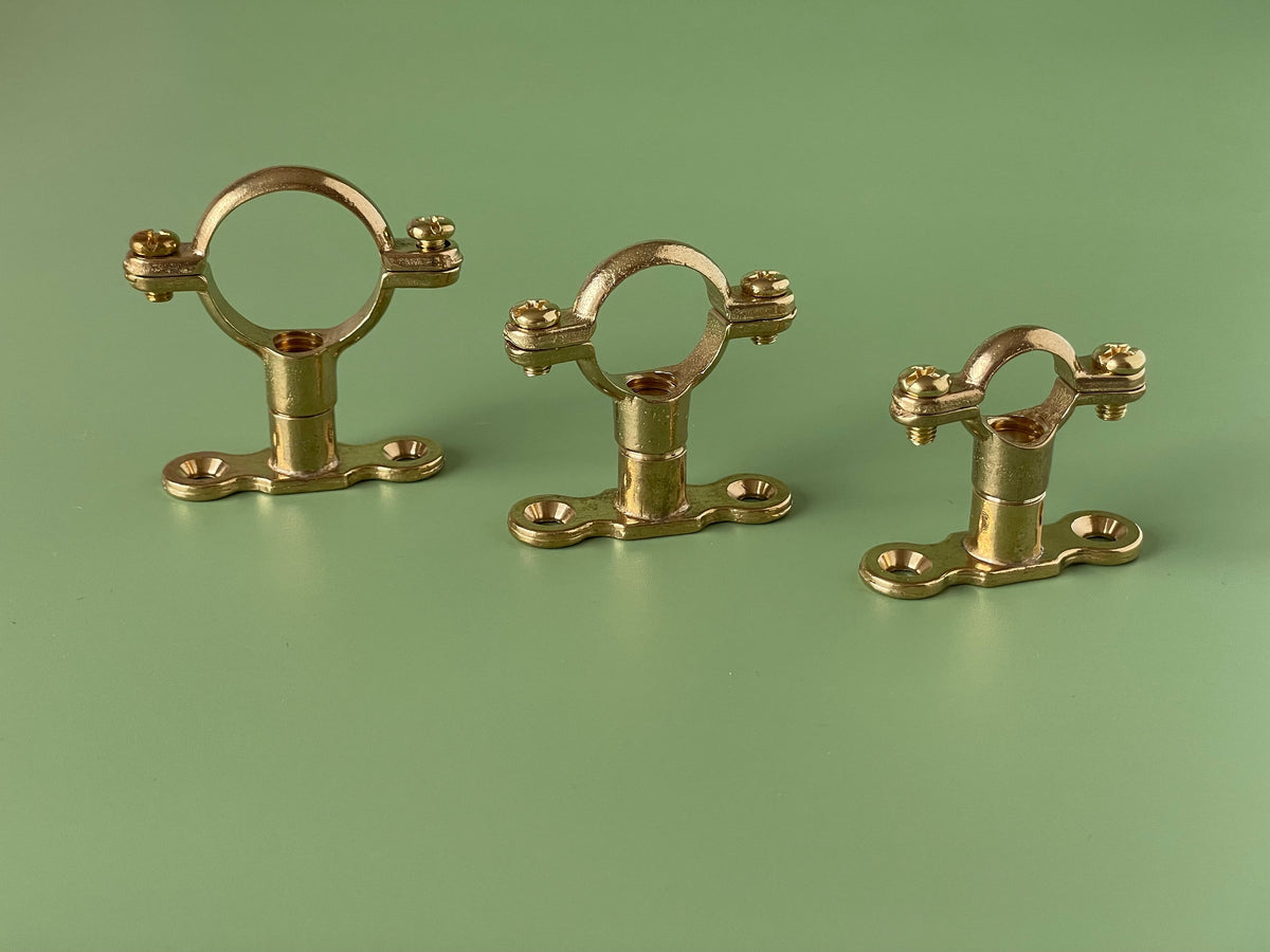 TALA solid brass pipe brackets mounted on wall for open timber shelving